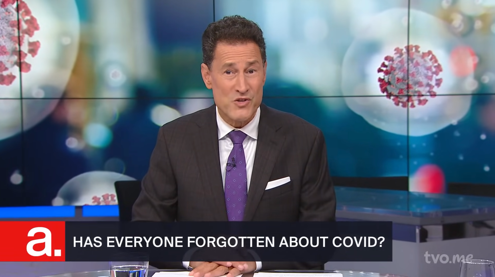 The host of The Agenda is pictured before a background of floating coronaviruses, the title card reads "Has everyone forgotten about COVID?".